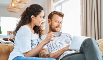Couple at computer on couch